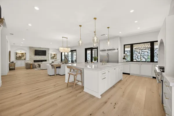 a large kitchen with a stove and a sink