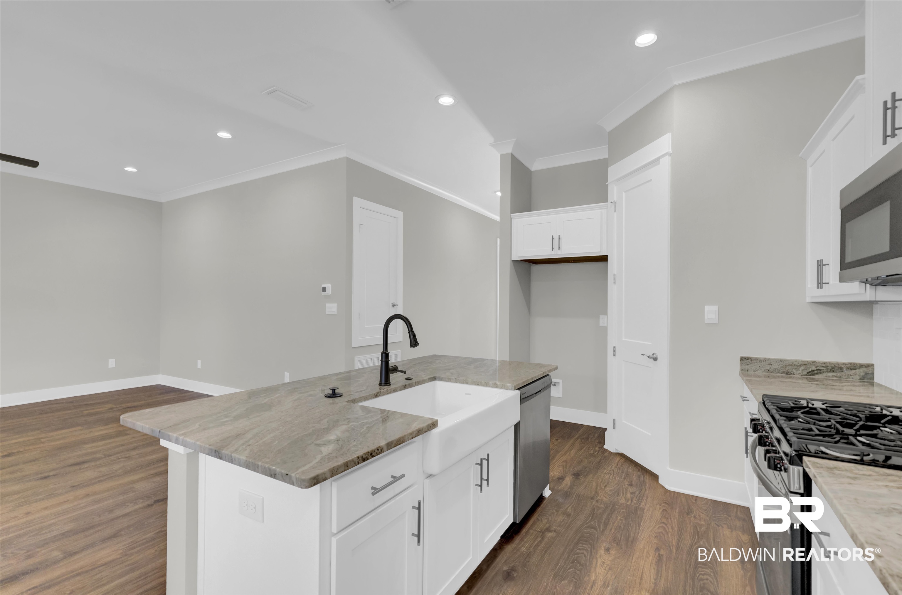 571 Morning Mist Way Fairhope, AL 36532 - Photo 9 of 47 Kitchen with white cabinetry, recessed lighting, stainless steel appliances, light stone countertops, and dark wood-style floors