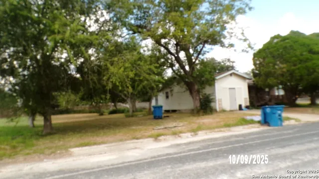 a view of a house with a yard and tree s