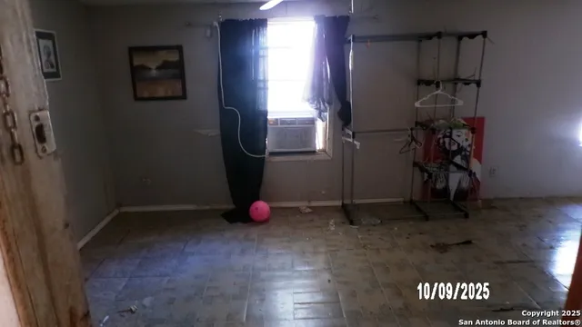 a view of storage and utility room with a window