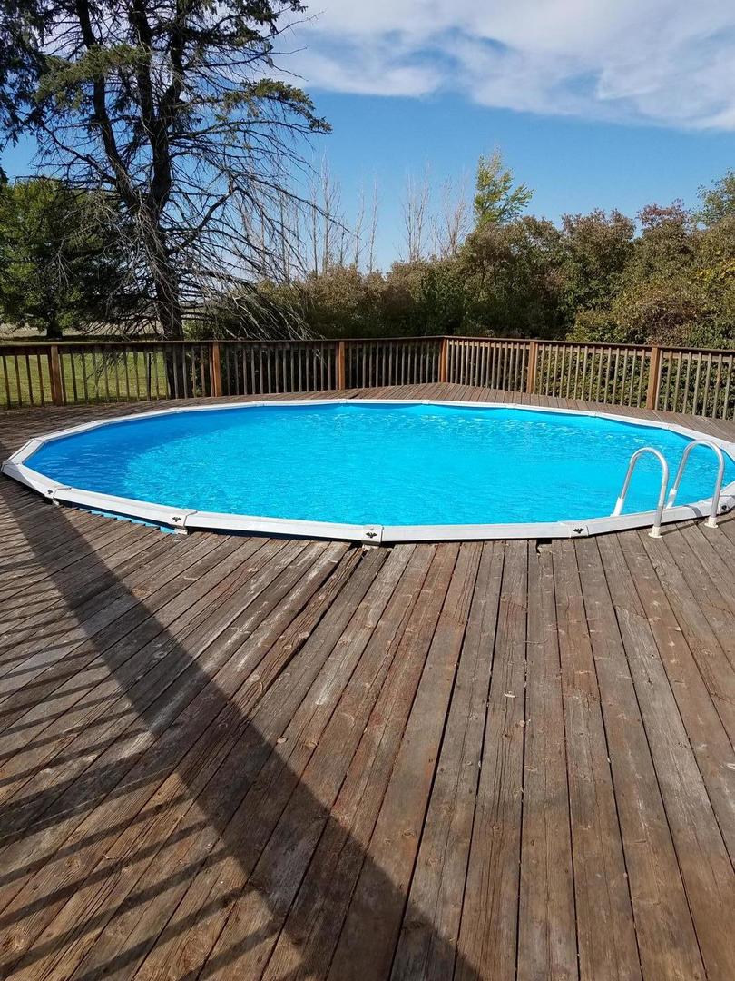 10481 Cherry Valley Road Genoa, IL 60135 - Photo 3 of 17 a view of a swimming pool with a yard
