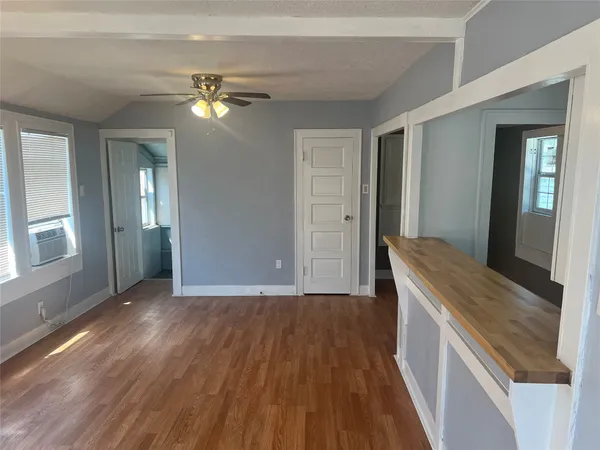 a view of a room with wooden floor and staircase