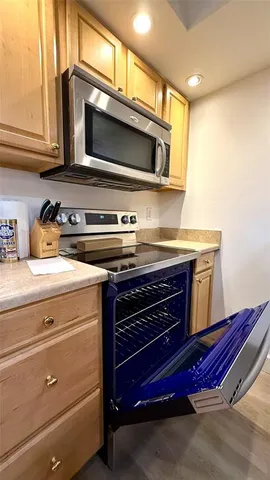 a stove top oven sitting inside of a kitchen