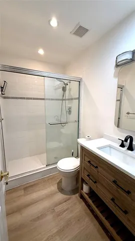 a bathroom with a toilet a sink and shower