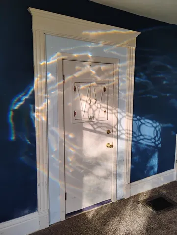 a view of wooden floor with entryway