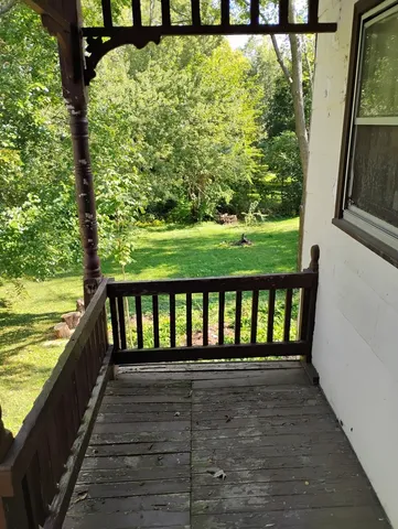 a view of balcony with yard