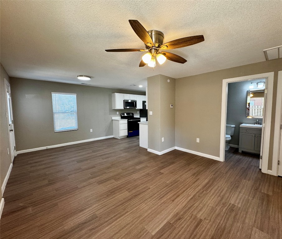 206 West N Loop Boulevard Austin, TX 78751 - Photo 2 of 11 a view of a livingroom with a ceiling fan and wooden floor