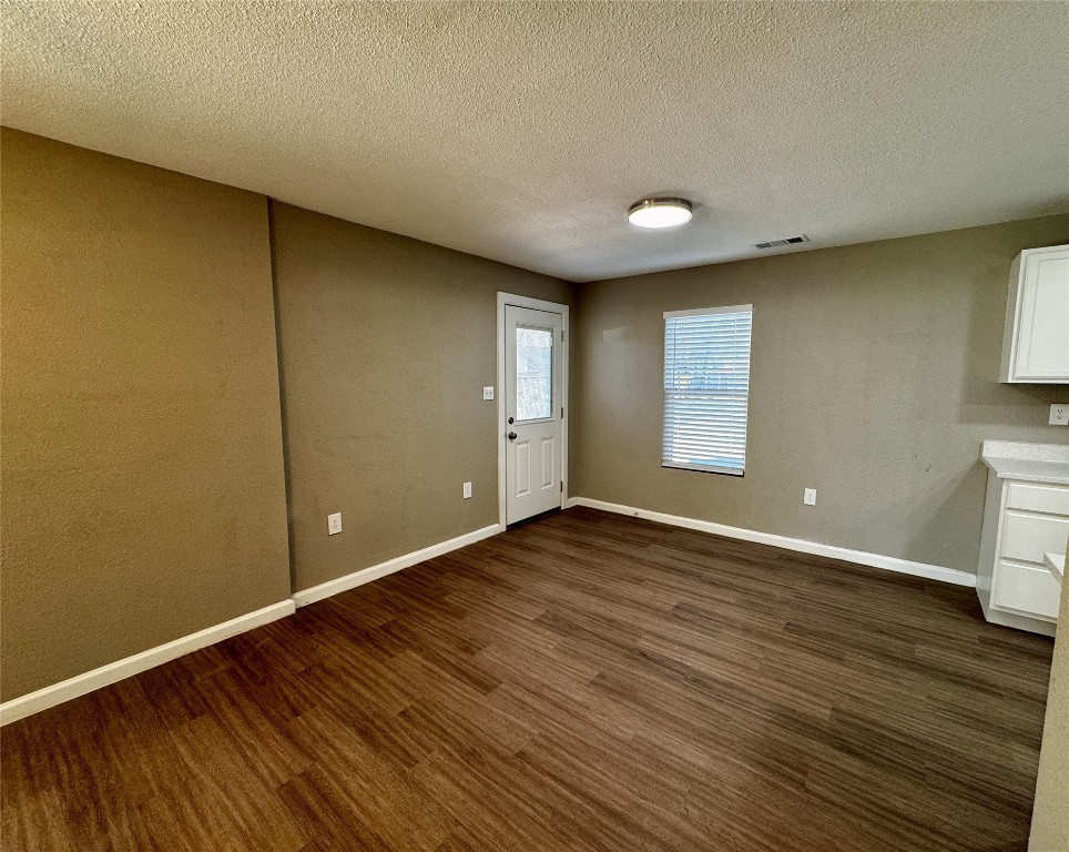 206 West N Loop Boulevard Austin, TX 78751 - Photo 4 of 11 a view of an empty room with wooden floor and a window