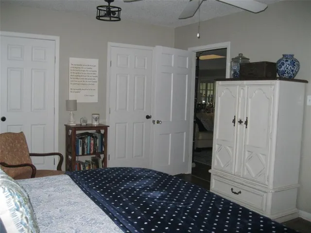 a bedroom with a bed and a chair