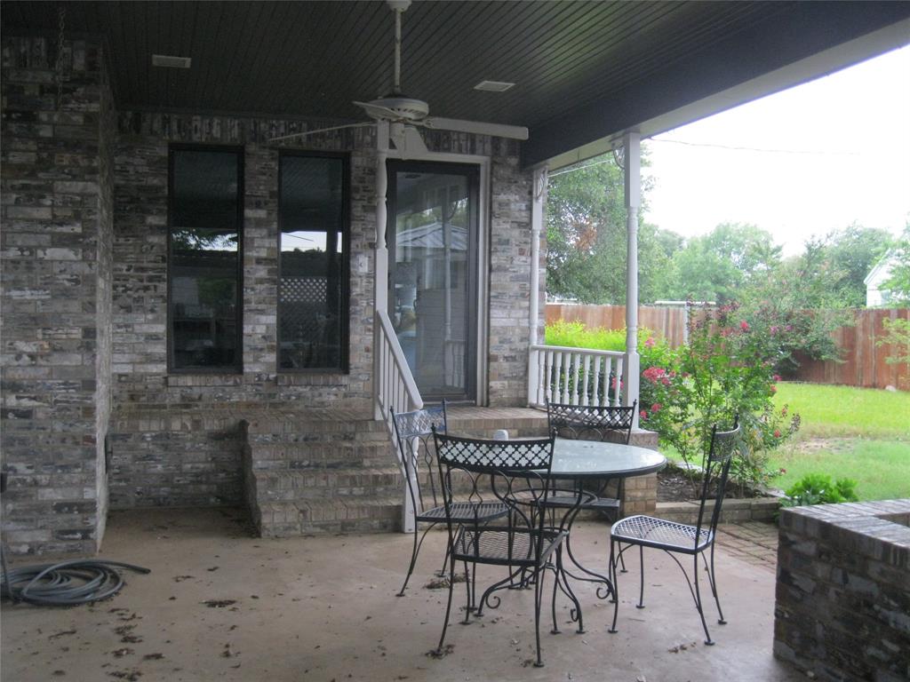 1302 West Wheeler Street Breckenridge, TX 76424 - Photo 36 of 40 a view of a porch with a table and chairs