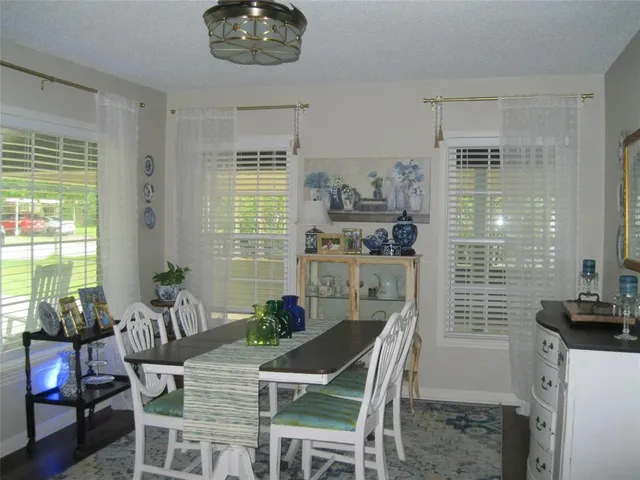 a dining room with furniture and window
