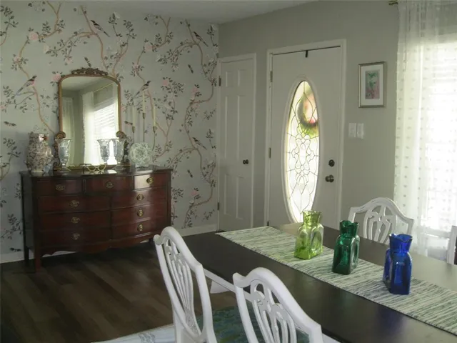 a dining room with furniture and a mirror
