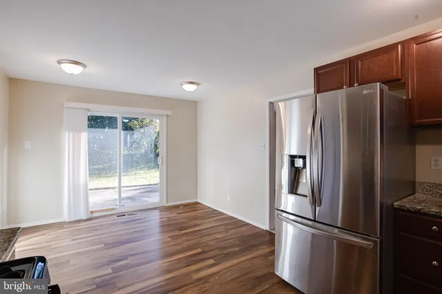 a view of a room with wooden floor and window