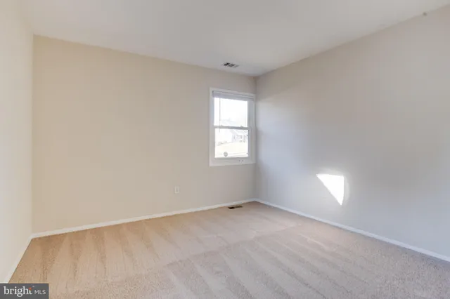 a view of an empty room and a window