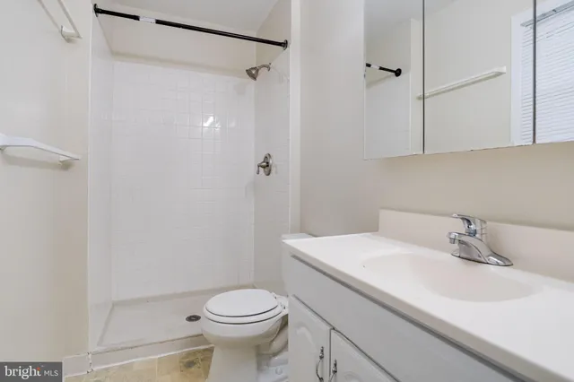 a bathroom with a shower and toilet