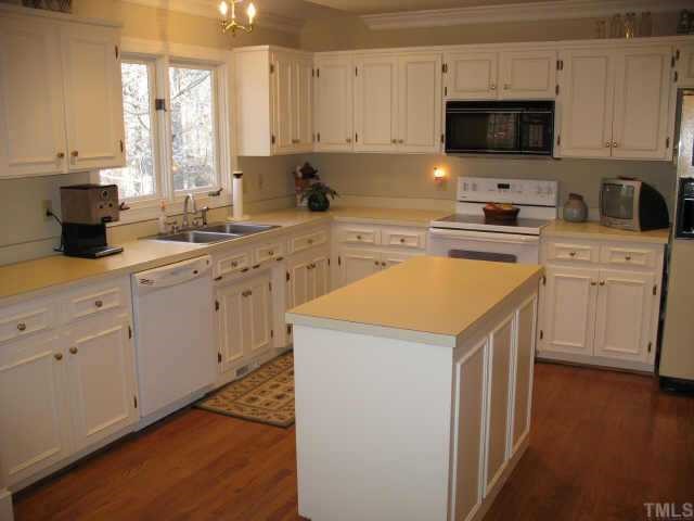 1405 Bascomb Drive Raleigh, NC 27614 - Photo 5 of 12 a kitchen with cabinets appliances a sink and a microwave
