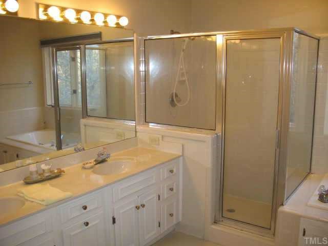 1405 Bascomb Drive Raleigh, NC 27614 - Photo 9 of 12 a bathroom with a shower sink and mirror