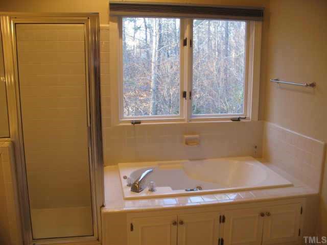 1405 Bascomb Drive Raleigh, NC 27614 - Photo 10 of 12 a bathroom with a tub and shower