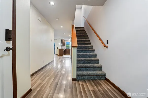 a view of entryway and hall with wooden floor