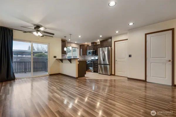 a view of a electric appliances in kitchen and an empty room