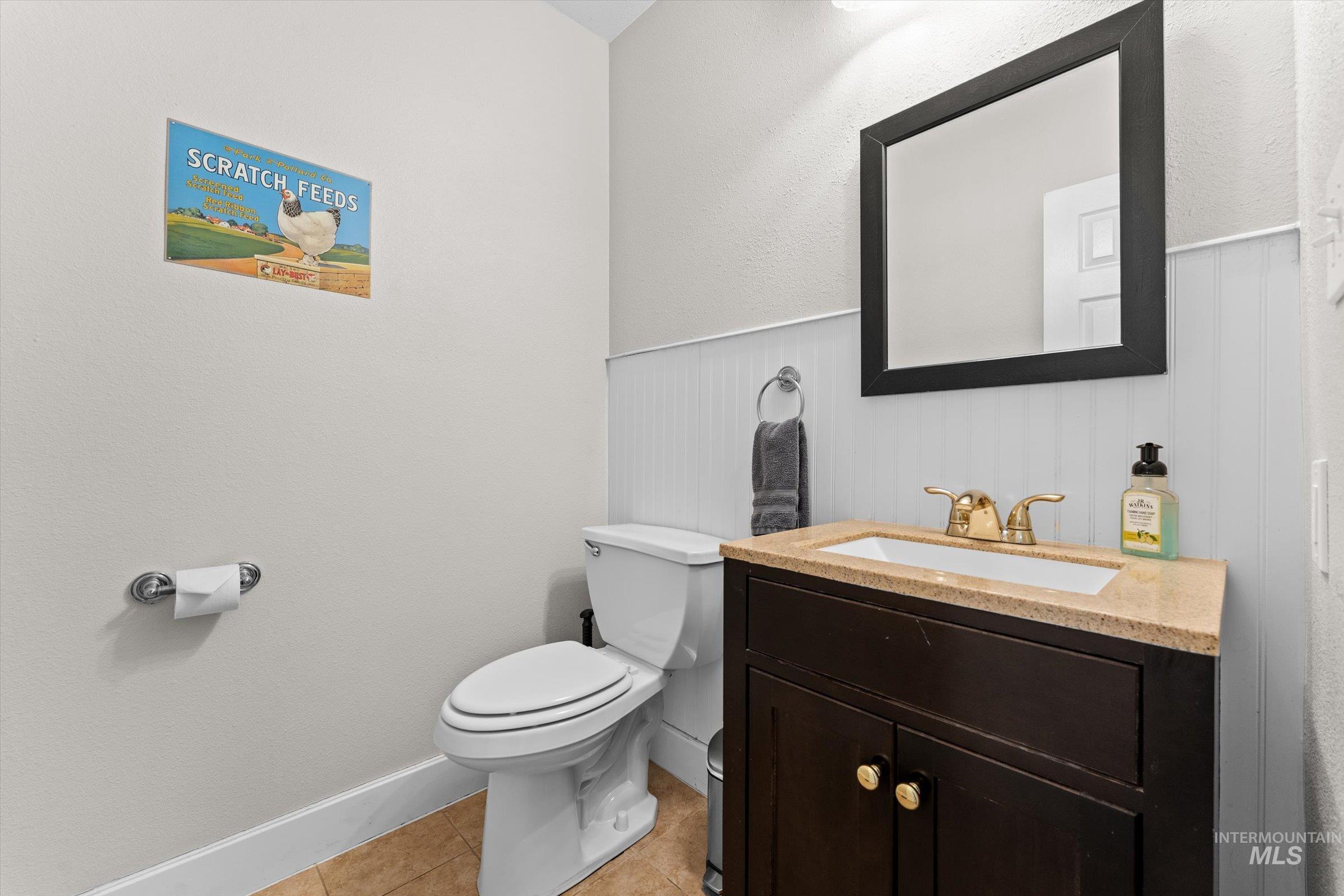 315 South Middlefork Road Garden Valley, ID 83622 - Photo 36 of 49 Bathroom with a textured wall, vanity, light tile patterned flooring, and a wainscoted wall