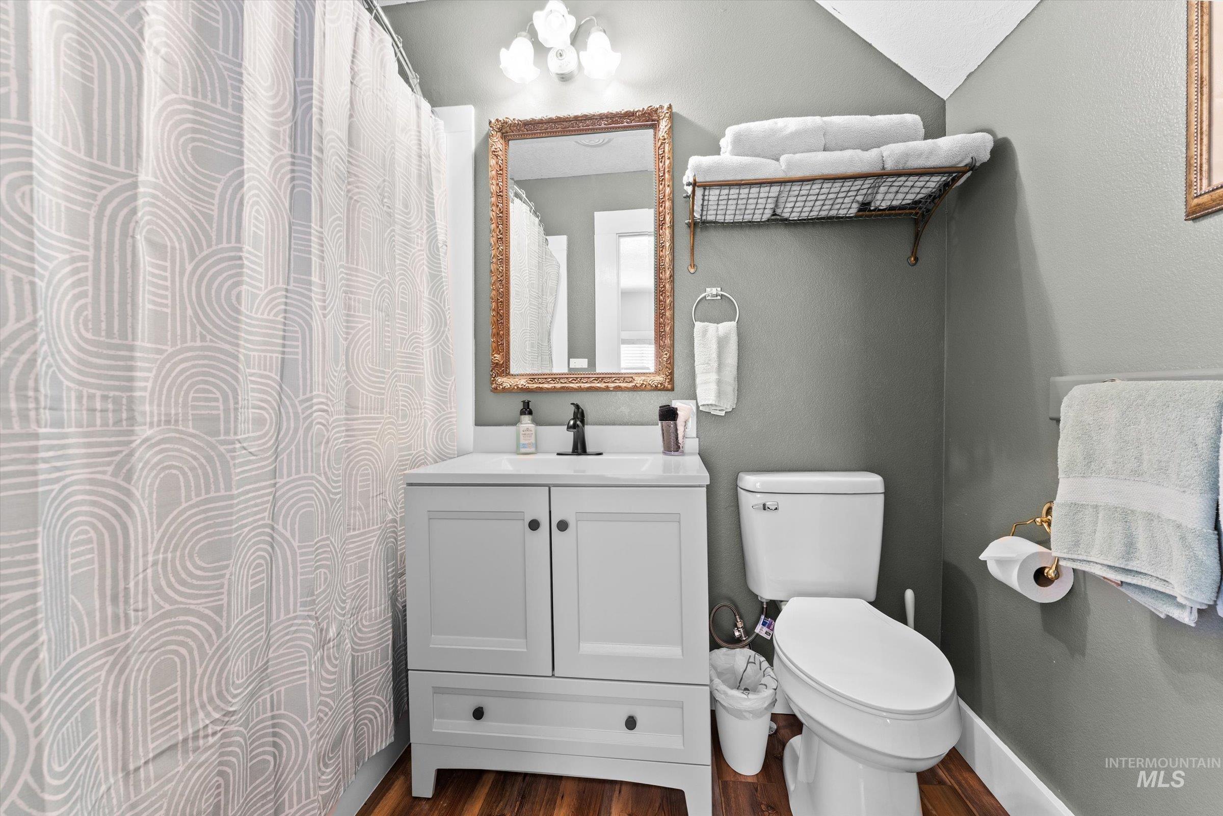 315 South Middlefork Road Garden Valley, ID 83622 - Photo 38 of 49 Full bath featuring vanity, dark wood finished floors, and a shower with shower curtain