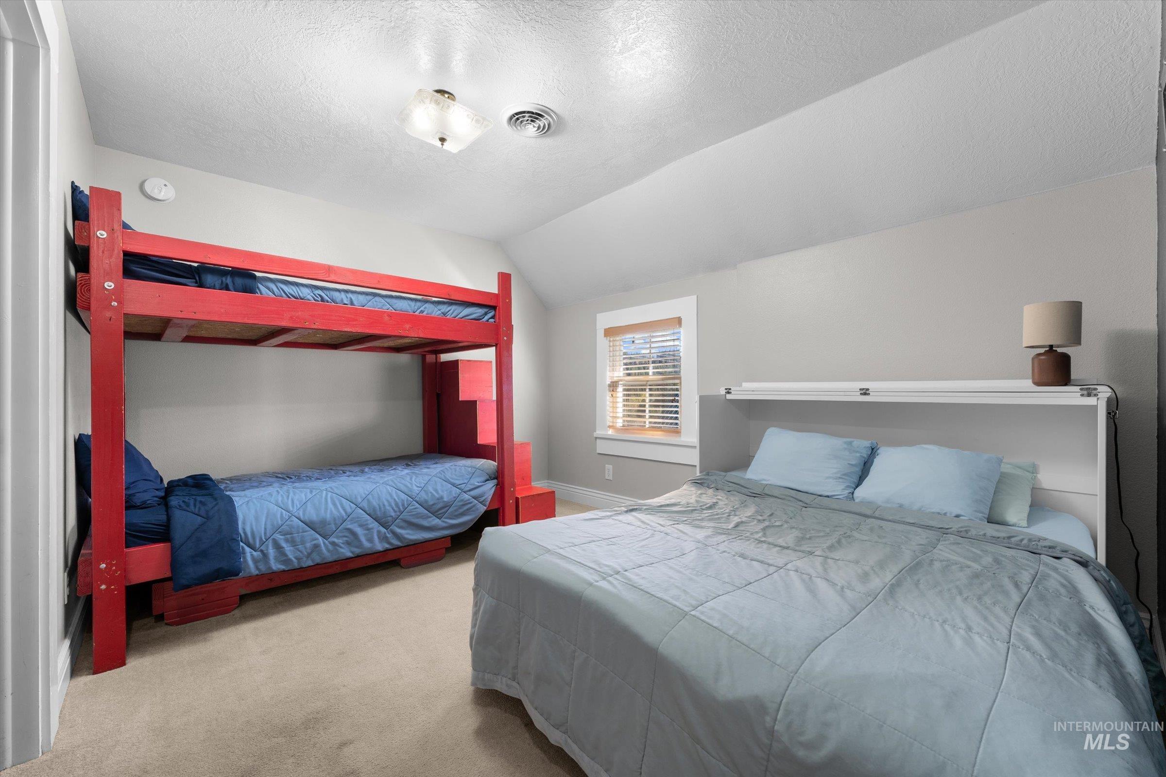315 South Middlefork Road Garden Valley, ID 83622 - Photo 40 of 49 Bedroom with vaulted ceiling, carpet, and a textured ceiling
