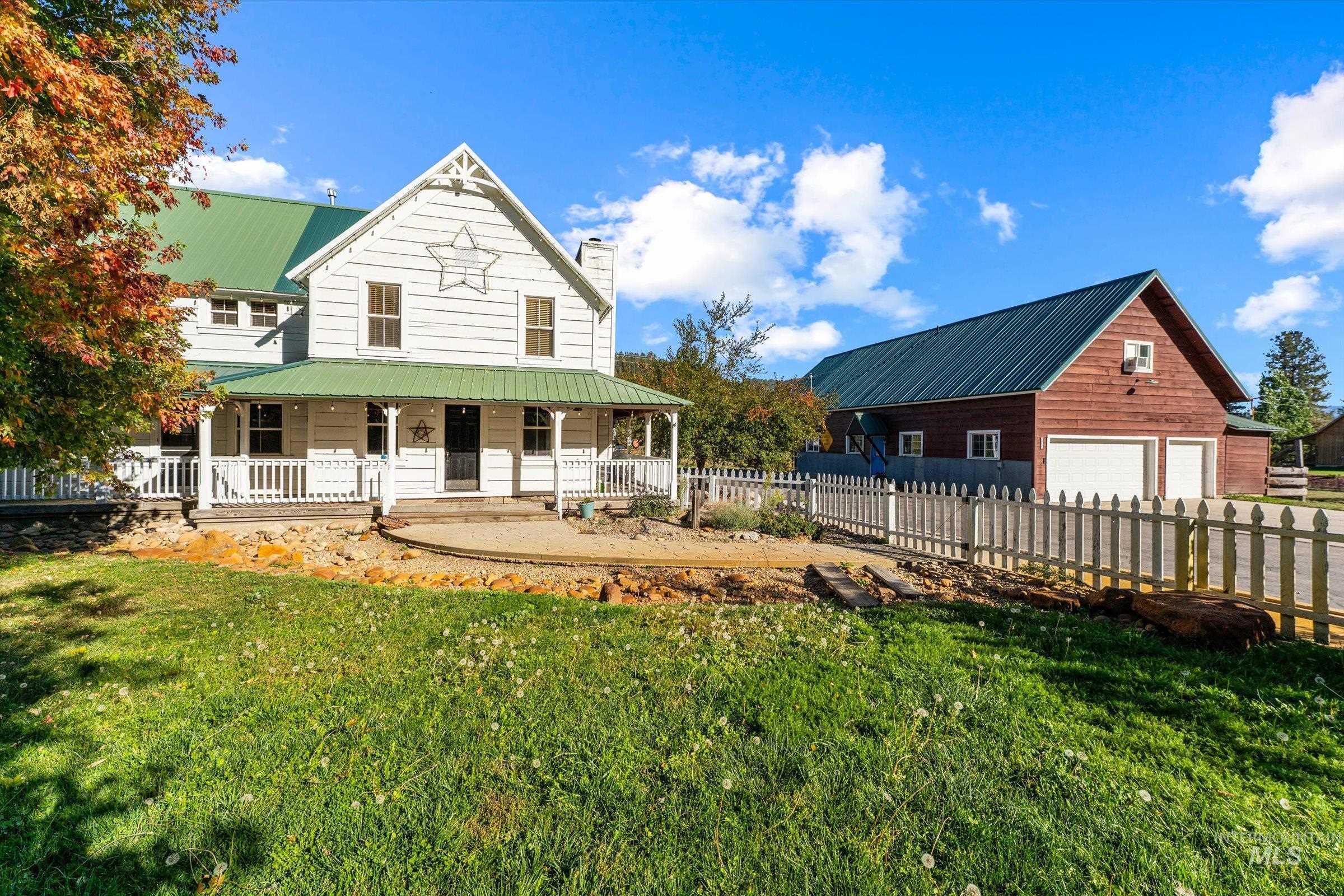 315 South Middlefork Road Garden Valley, ID 83622 - Photo 41 of 49 Back of property featuring covered porch, a chimney, a metal roof, and an outbuilding
