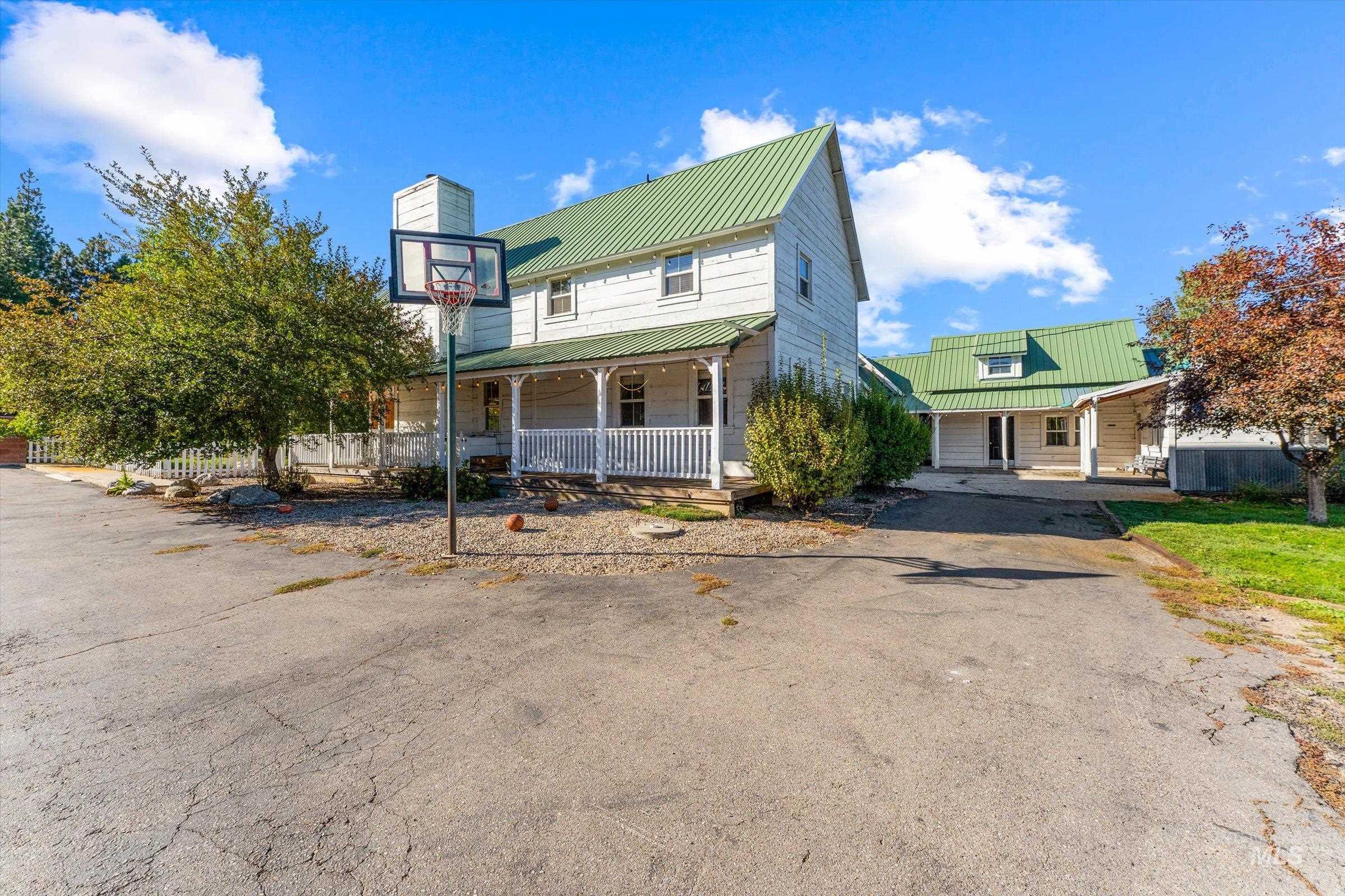 315 South Middlefork Road Garden Valley, ID 83622 - Photo 46 of 49 View of front of house with covered porch, a metal roof, and a chimney