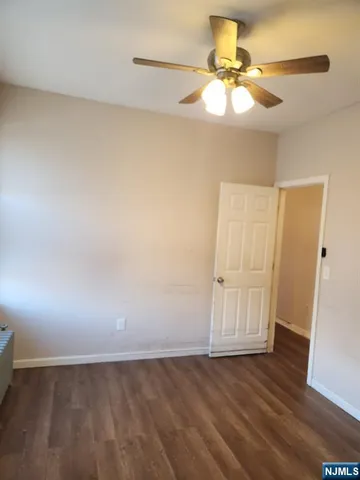 a view of an empty room and wooden floor