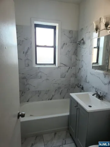 a white bath tub sitting next to a white sink