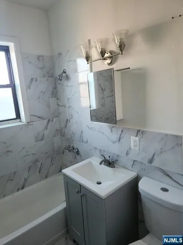 a bathroom with a sink toilet and bathtub