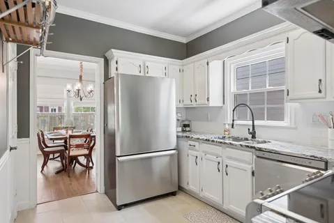 a white refrigerator freezer sitting inside of a kitchen