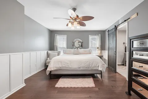 a bedroom with a bed and a chandelier