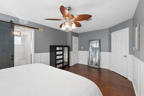 a bedroom with a bed and a chandelier
