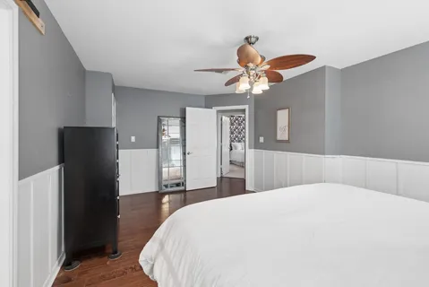 a bedroom with a bed and a chandelier
