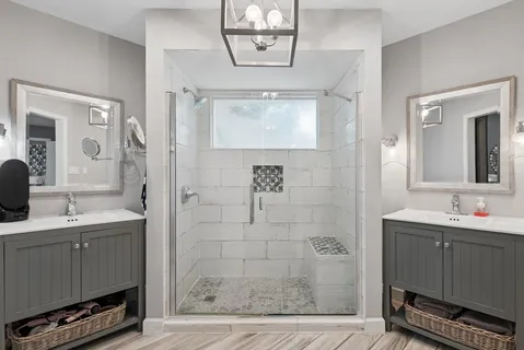 a bathroom with a sink a mirror and a shower