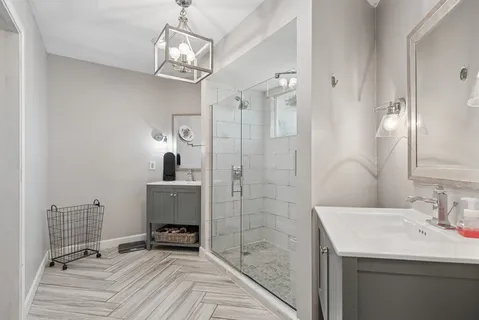a bathroom with a sink a mirror and shower