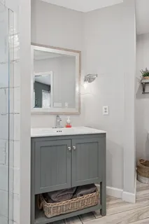 a bathroom with a sink a mirror and vanity