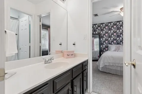 a en suite bathroom with a sink and a mirror