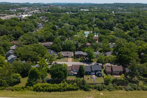 an aerial view of a house with a field
