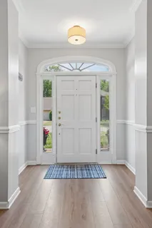 an entryway with wooden floor