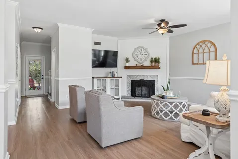a living room with furniture fireplace and flat screen tv