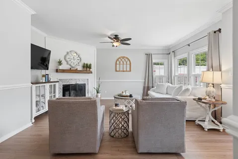 a living room with furniture a fireplace and a flat screen tv