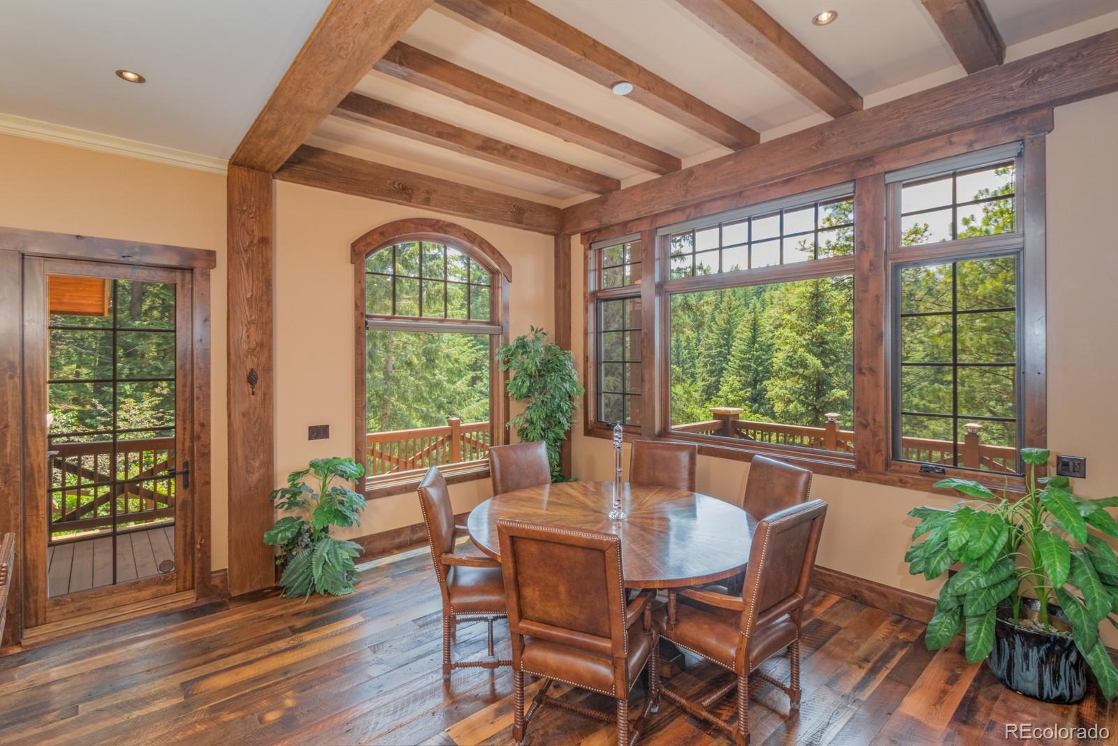 30 West Ranch Trail Morrison, CO 80465 - Photo 13 of 40 a dining room with furniture window and wooden floor
