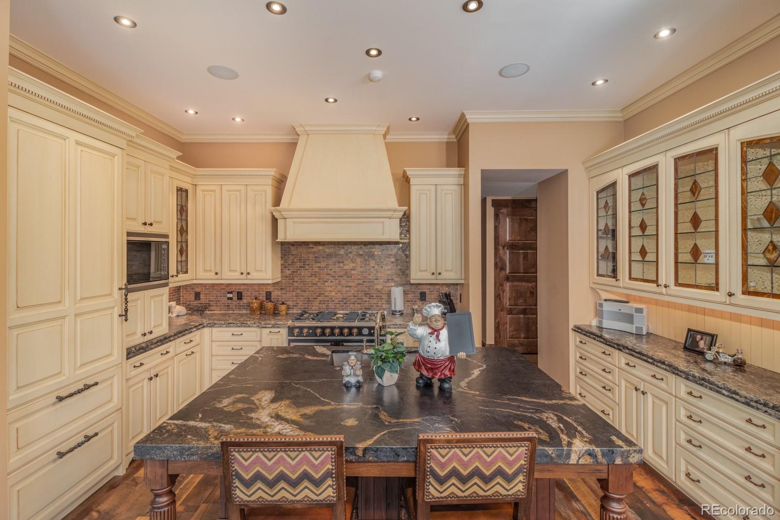 30 West Ranch Trail Morrison, CO 80465 - Photo 14 of 40 a kitchen with granite countertop a stove a sink and a refrigerator