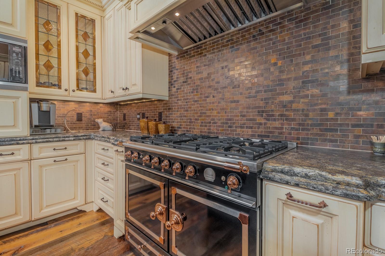 30 West Ranch Trail Morrison, CO 80465 - Photo 15 of 40 a stove top oven sitting inside of a kitchen