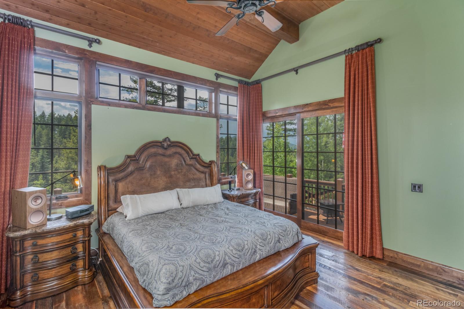 30 West Ranch Trail Morrison, CO 80465 - Photo 18 of 40 a bedroom with a bed and wooden floor