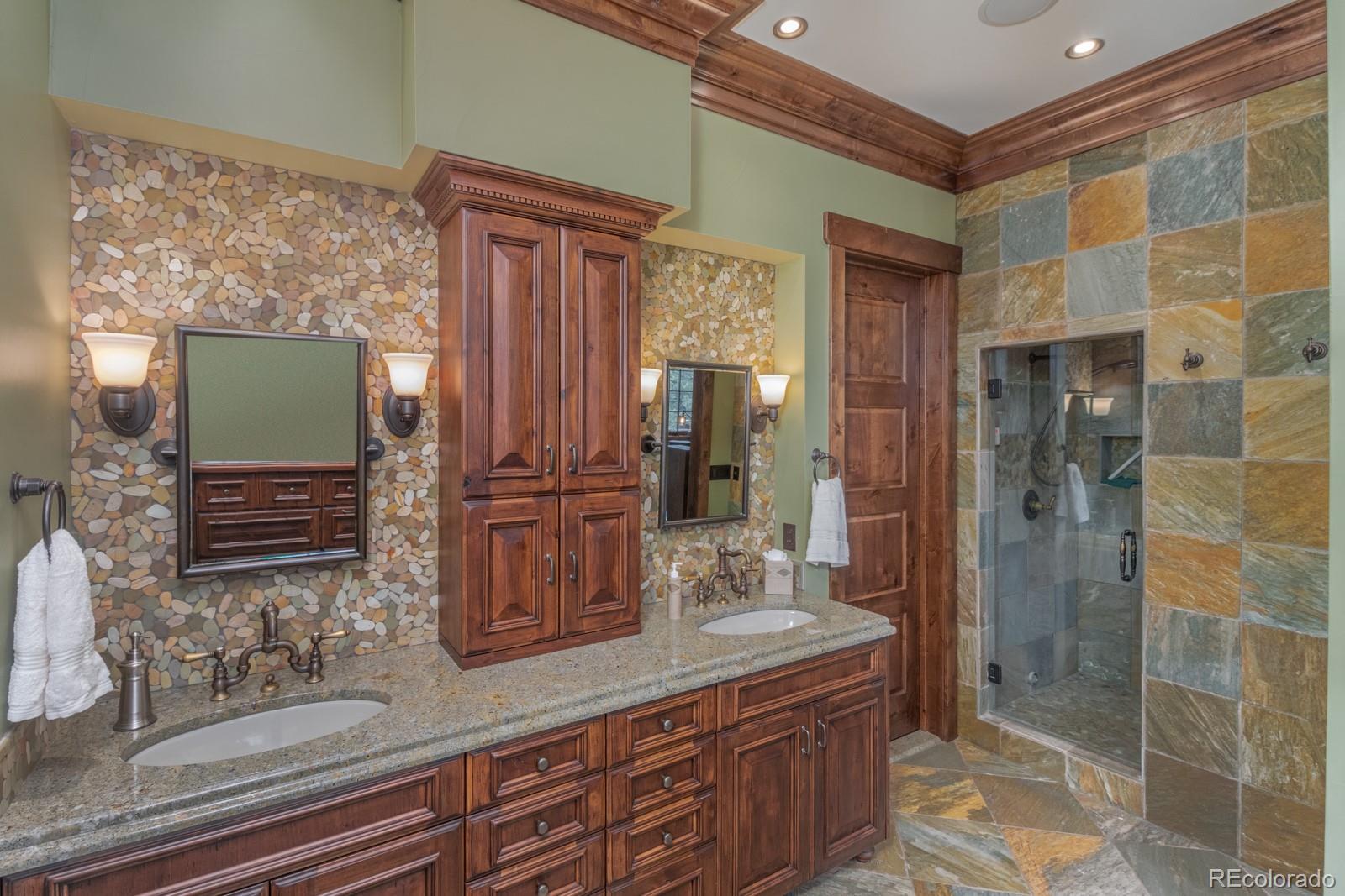30 West Ranch Trail Morrison, CO 80465 - Photo 21 of 40 a bathroom with a double vanity sink mirror and shower
