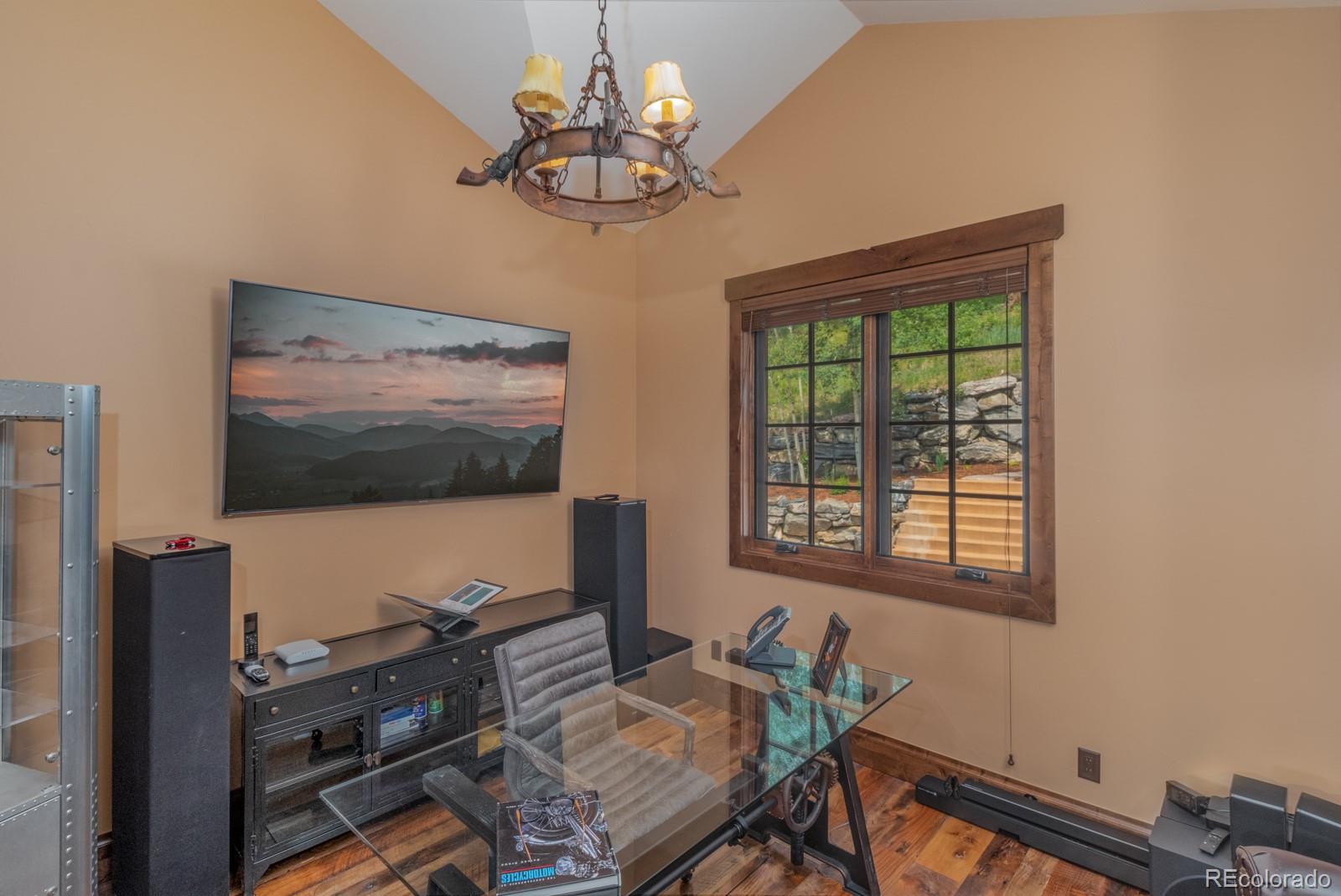 30 West Ranch Trail Morrison, CO 80465 - Photo 22 of 40 a living room with furniture and a flat screen tv
